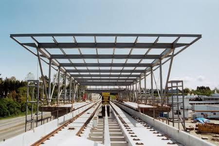 Steel structural frame under construction for a long-span railway station roof.